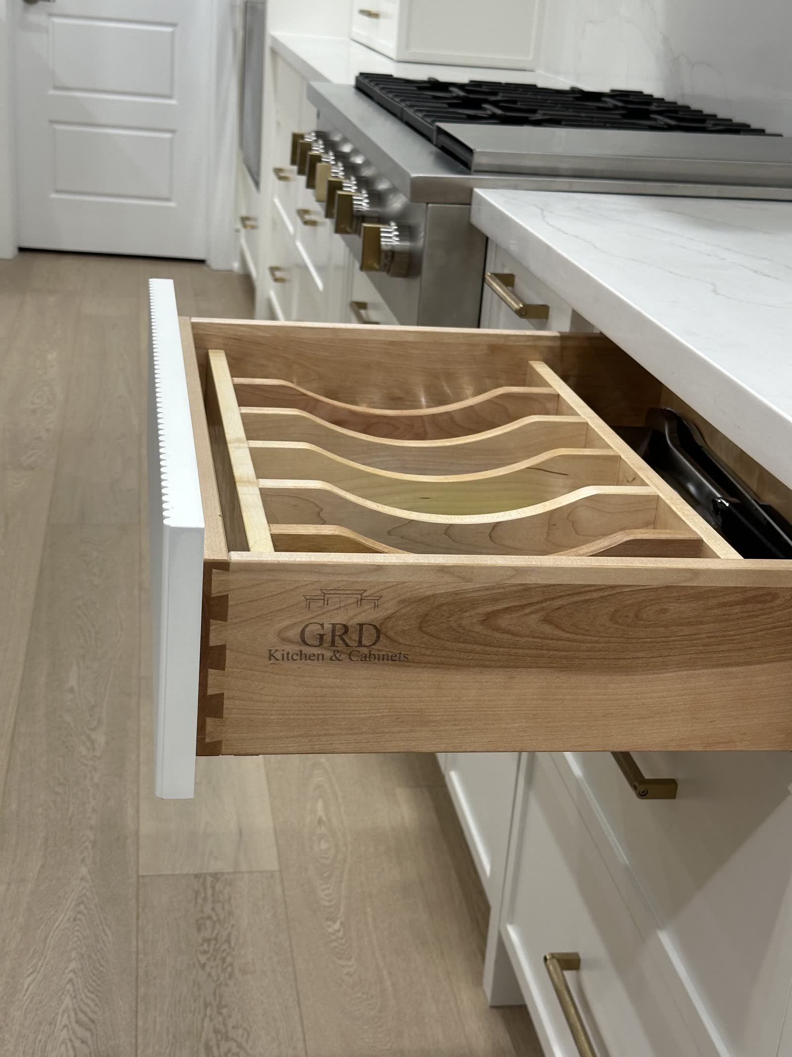 Solid maple dovetailed drawer box with a fitted plate organiser and the GRD mark branded into the side